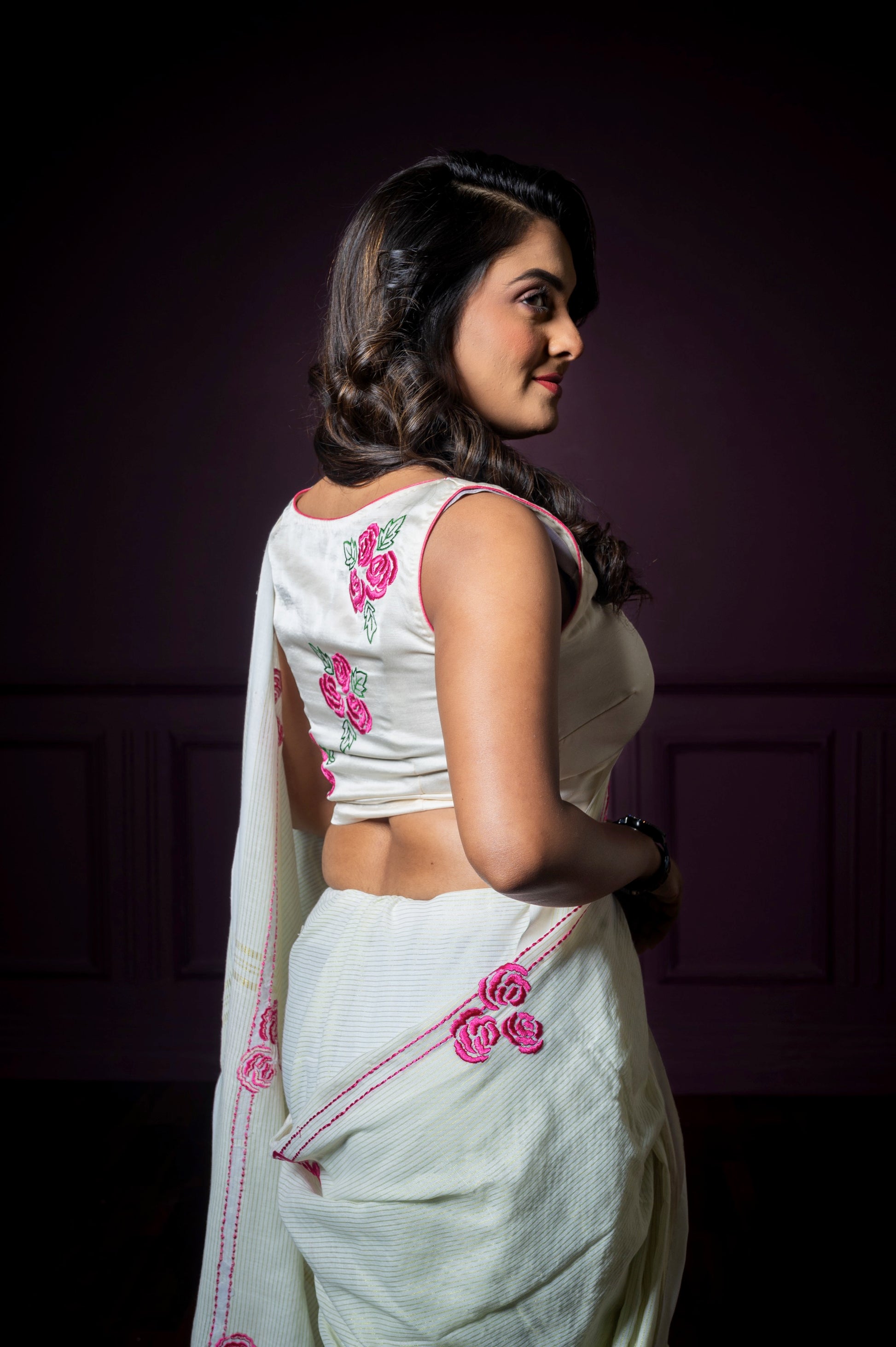 Side-back angle highlighting the detailed embroidery on the Gul-e-Bahar blouse with matching floral motifs on the saree.