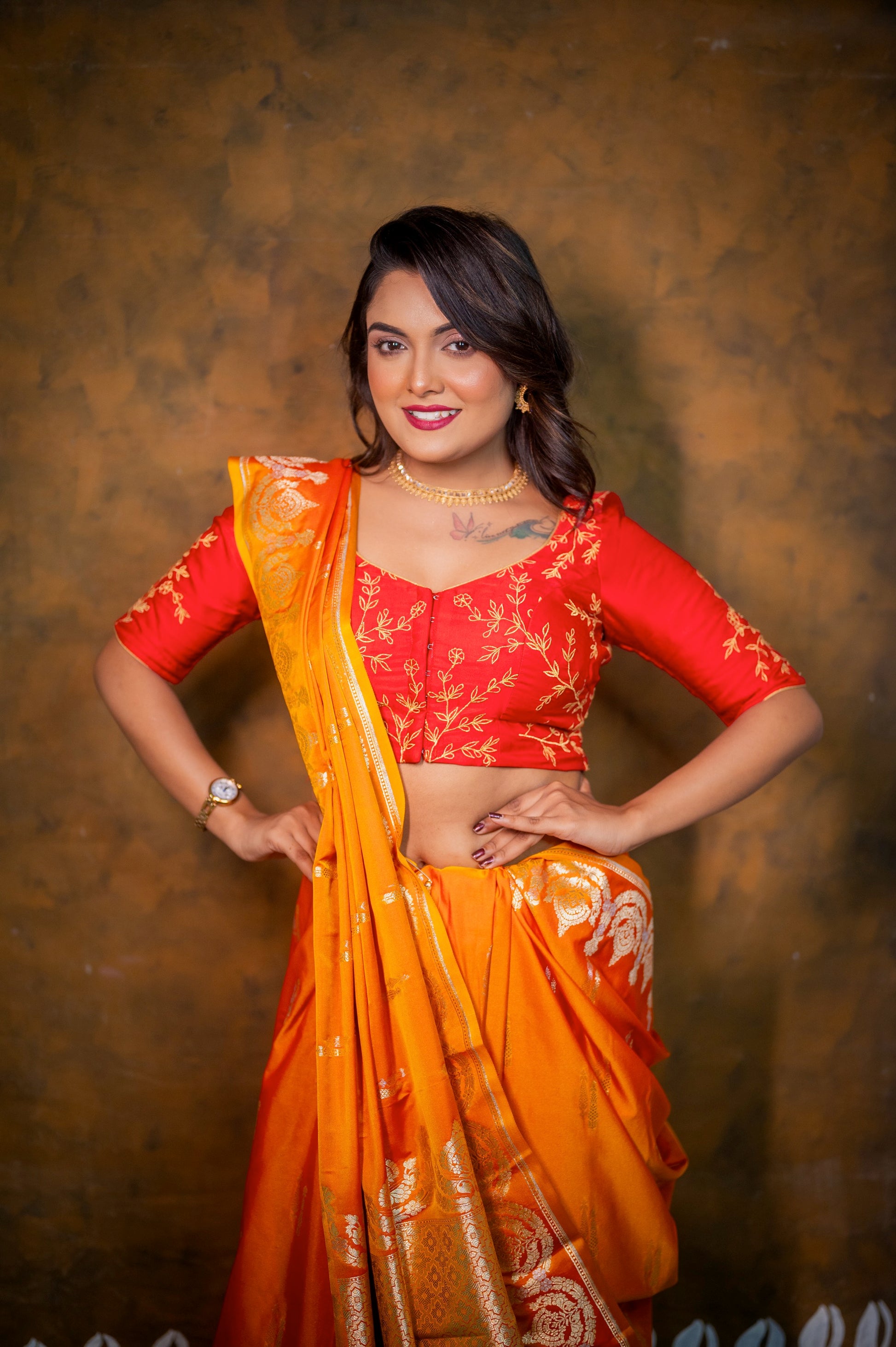 Front view of the red semi-silk blouse showcasing detailed floral embroidery and a flattering neckline.