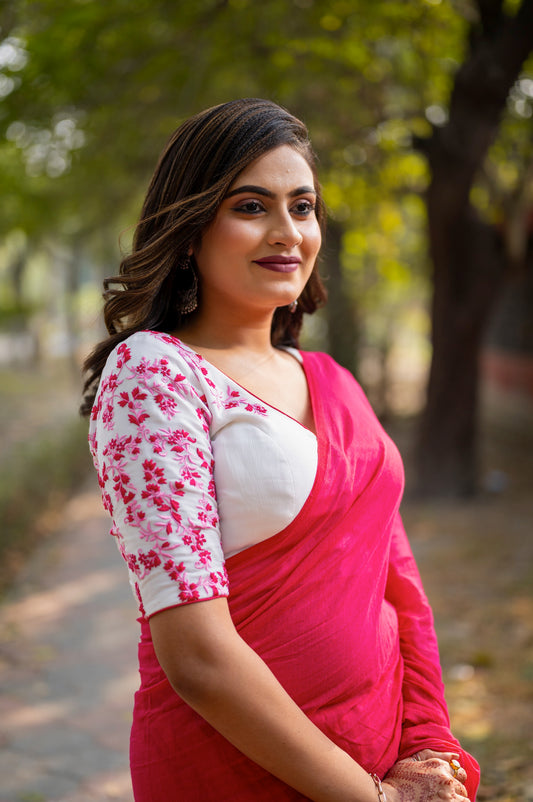Front view of dusty rose pink embroidered blouse with floral threadwork and structured fit