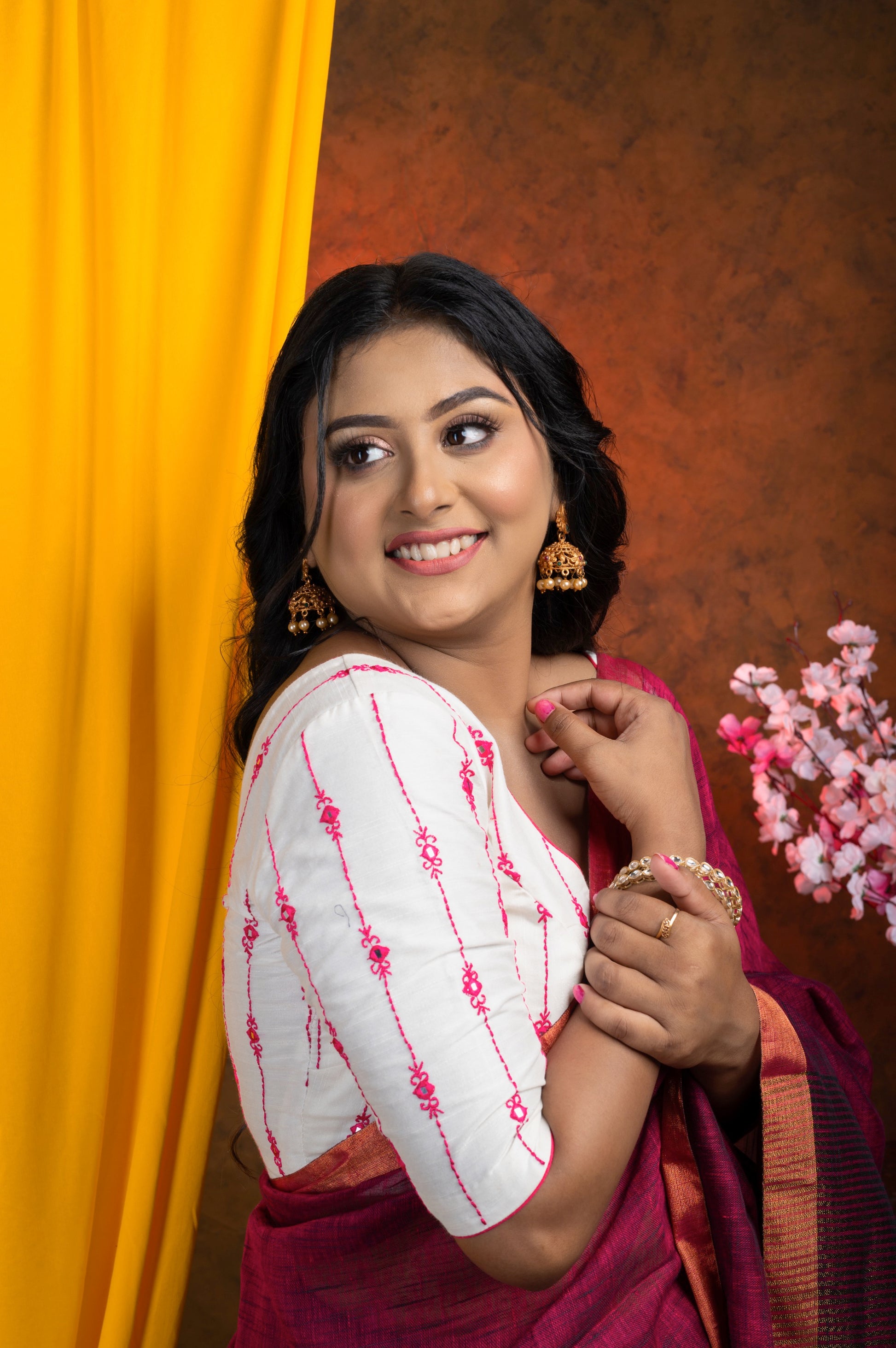 Shoulder View of a a crisp white cotton-linen blouse with rich dark rani silk thread embroidery and a classic wide V neckline — perfect for cotton handloom and mulmul sarees