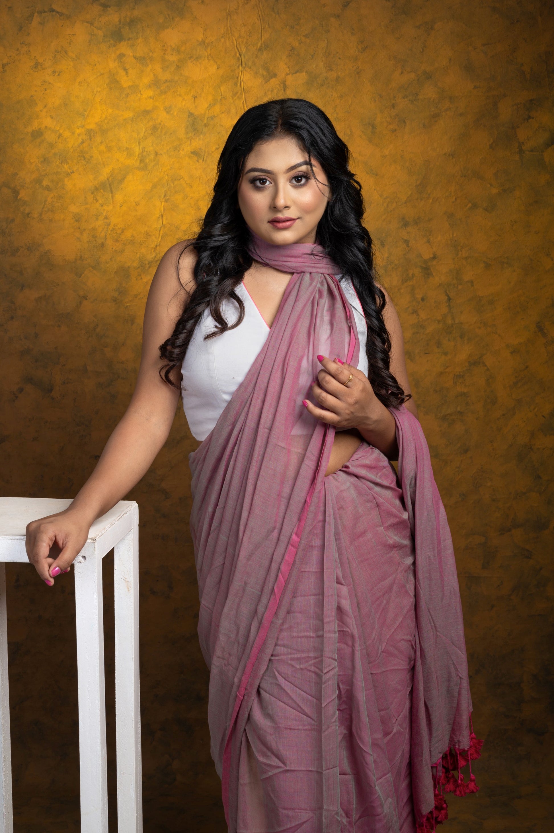 Front view of sleeveless white cotton-linen blouse with boat neckline, styled with a mauve mulmul saree for a breezy summer look