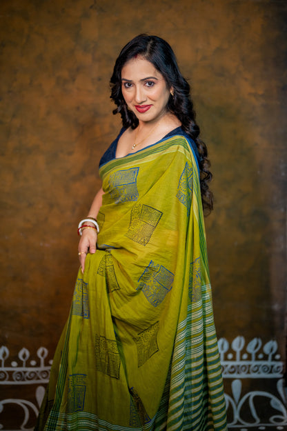 Woman flaunting front view of blue jamebar blouse with statement neckline and contrasting saree.